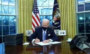 91279354 us president joe biden signs executive orders in the oval office of the white house in wash
