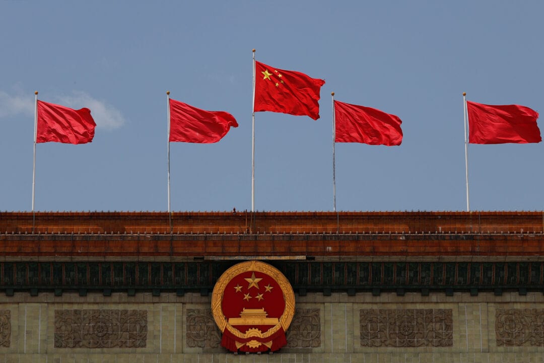 chinese flag flutters at the great hall of the people in beijing